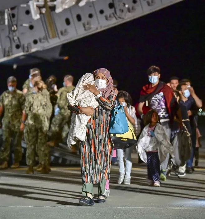 Framed Print : A young Afghan refugee mother carries her bundled child as she walks from the US Air Force C-17 in Sigonella, Italy Framed Print : A young Afghan refugee mother carries her bundled child as she walks from the US Air Force C-17 in Sigonella, Italy