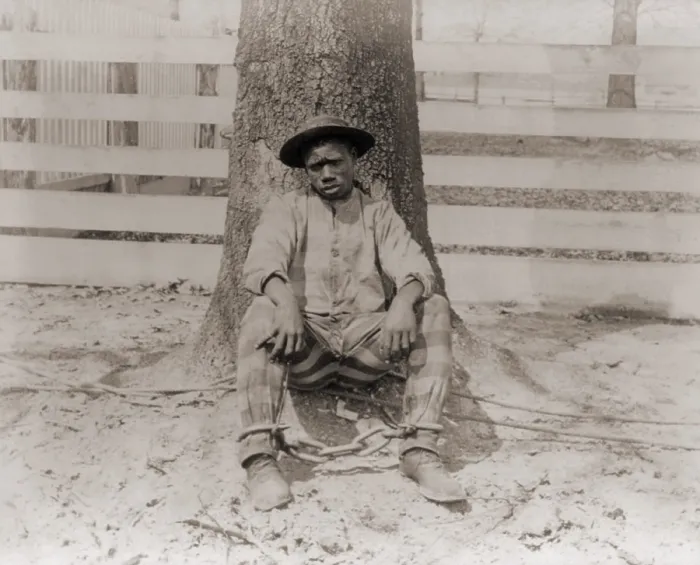 Framed Print : Young African American sitting with legs chained, Thomasville, Georgia. 1890