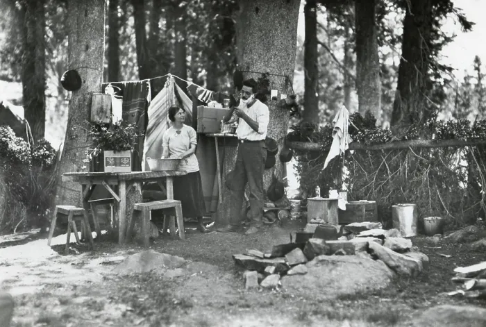 Framed Print : Young couple camping at the Lake Basin Public Camp, Cleveland National Forest, California, 1922. The camp ground has a table with benches and a concrete fireplace