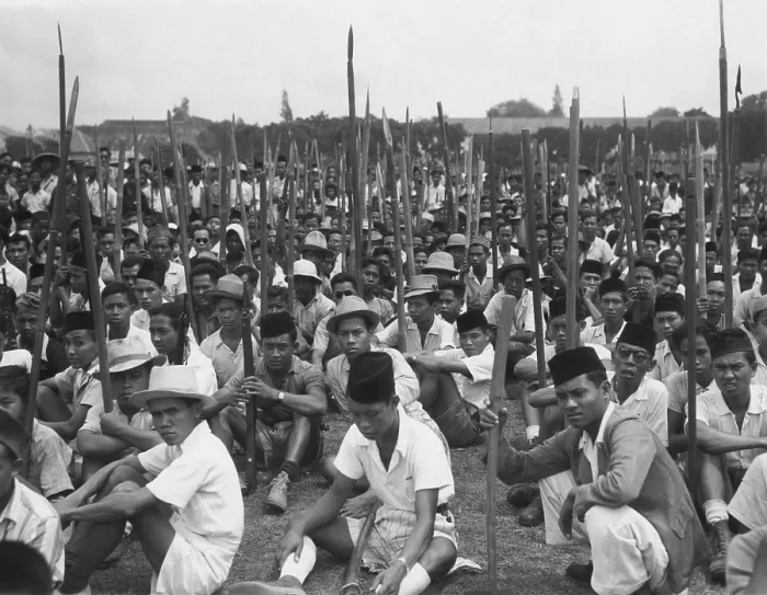 Framed Print : Young Indonesian men seated on ground holding sharpened bamboo poles Framed Print : Young Indonesian men seated on ground holding sharpened bamboo poles