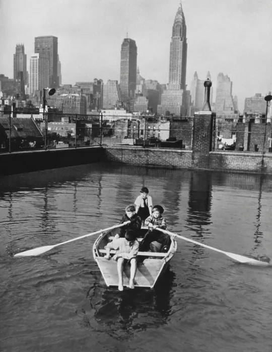 Framed Print : Four young members of the Madison Square Boy's Club rowing a boat in a rooftop pool. Manhattan skyscrapers are in the background, Feb. 1950. (BSLOC_2014_13_177) Framed Print : Four young members of the Madison Square Boy's Club rowing a boat in a rooftop pool. Manhattan skyscrapers are in the background, Feb. 1950. (BSLOC_2014_13_177)