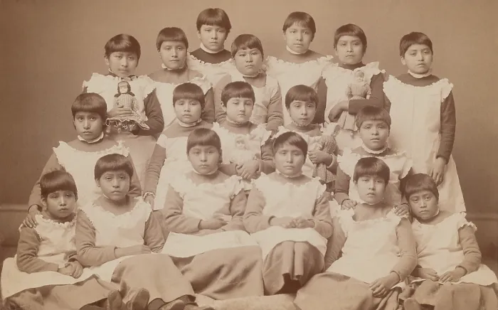 Framed Print : Young Native American girls, approximately ages 6-12, pose for a group portrait at the United States Indian School, Carlisle, Pennsylvania, ca. 1880-1900