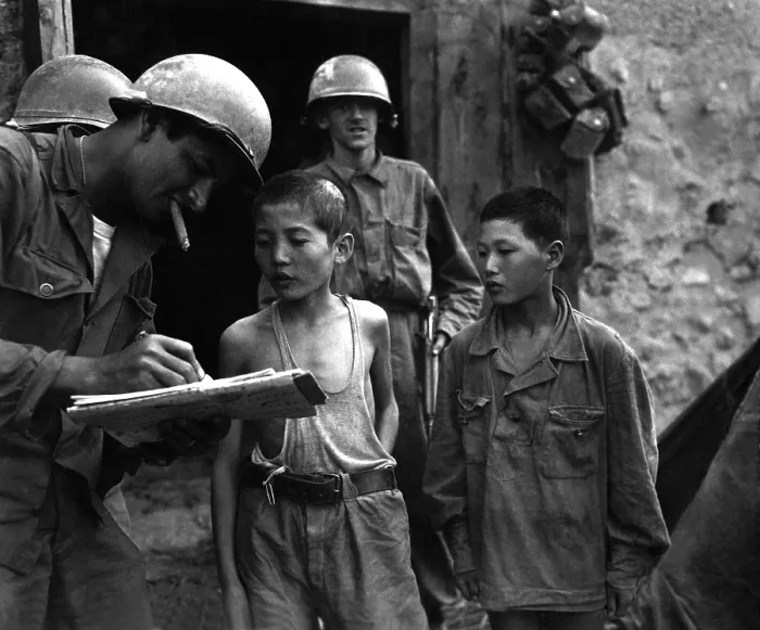 Framed Print : Two young North Korean soldiers taken prisoner in the Sindang-dong area (near Seoul). They are interrogated by a U.S. soldier shortly after their capture. Sept. 18, 1950