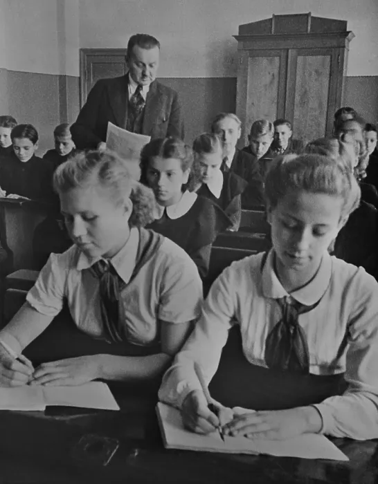 Framed Print : Young Pioneer girls sitting at the front desk in a Latvian USSR sixth grade classroom. They wear the red scarfed uniforms of the Communist youth organization in 1940 Framed Print : Young Pioneer girls sitting at the front desk in a Latvian USSR sixth grade classroom. They wear the red scarfed uniforms of the Communist youth organization in 1940