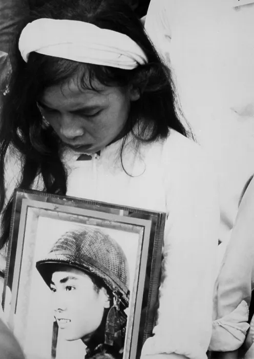 Framed Print : An young Vietnamese widow mourns. Hugging a photo of her missing husband, she attends a mass funeral service for 400 killed in Hue during the Tet Offensive. Oct. 14, 1968