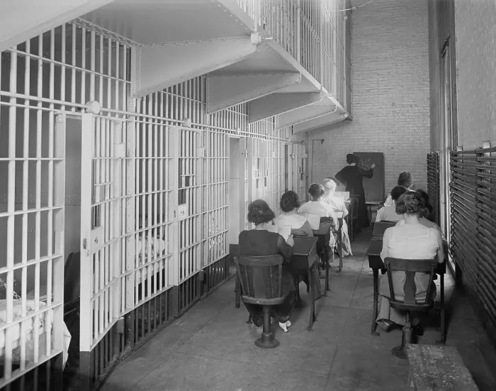 Framed Print : Young women at desks in an American jail c. 1920. Dressed in street clothing, they sit in two rows of desks in a cellblock Framed Print : Young women at desks in an American jail c. 1920. Dressed in street clothing, they sit in two rows of desks in a cellblock