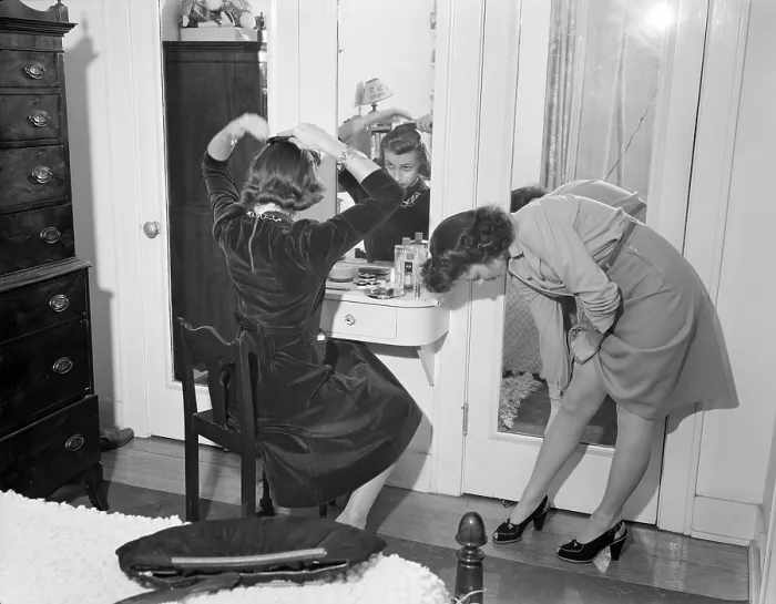 Framed Print : Young women dressing up in Detroit, Michigan. One is straightening her stocking seams, while another girl combs her hair at a mirror. Summer, 1941. (BSLOC_2013_14_184) Framed Print : Young women dressing up in Detroit, Michigan. One is straightening her stocking seams, while another girl combs her hair at a mirror. Summer, 1941. (BSLOC_2013_14_184)