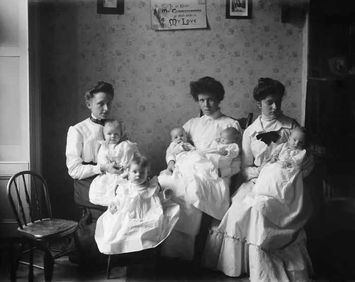 Framed Print : Three young women hold five babies at the Childrens Aid Society