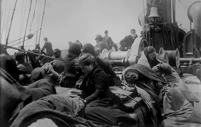 Framed Print : A young women reading on the steerage deck of an ocean liner approaching the Port of New York