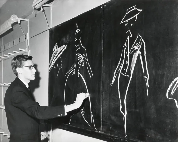 Framed Print : Yves Saint Laurent sketching designs for Christian Dior 1958 fashion line in Paris