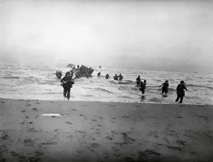 Mediterranean Sea Prints: 143rd Infantry regiment Combat Team running onto a beach on the Gulf of Salerno