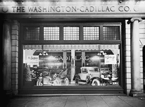 Convertible Prints: 1927 Cadillac LaSalle (right) shares the showroom window with a vintage model
