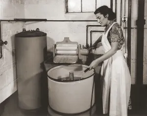 1930s state of the art home laundry included a hot water heater, Hose filled wash tub with electric powered agitator and wringer