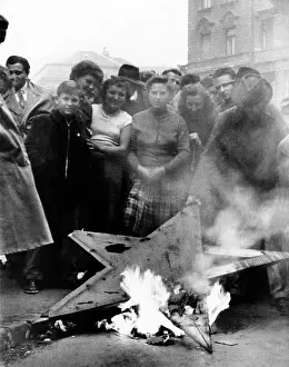 The 1956 Hungarian Uprising. Civilians stand around a destroyed Red Star, a Soviet symbol in University Square. Budapest Hungary. Oct. 23-Nov 4, 1956