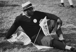 Marchers Prints: 1963 March on Washington. A male marcher relaxing on the grass of the Capitol Mall