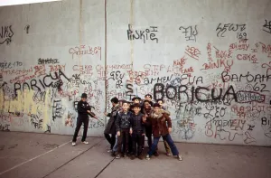 Ethnic Prints: 1970s America. Young boys pose in front of a graffitied wall in a park in the Bronx