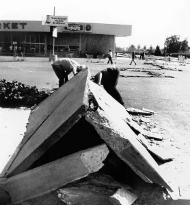 Earthquakes Prints: 1971 San Fernando Earthquake. Two boys look under a section of buckled concrete in downtown Sylmar