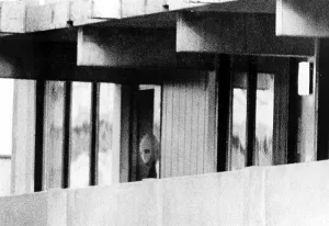 Images Dated 28th June 2025: 1972 Olympics, Terrorist from Black September peers out of apartment in Olympic Village