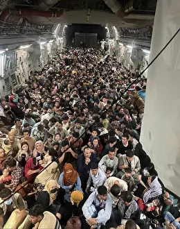 Families Prints: 823 Afghan refugees inside a US Air Force C-17 enroute from Kabul to Qatar on Aug