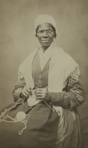 Shawl Prints: Abolitionist Sojourner Truth, sits with yarn and knitting needles, 1864