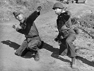 Throwing Prints: Actor Gregory Peck (right) gets a lesson in hand grenade throwing from Army Capt