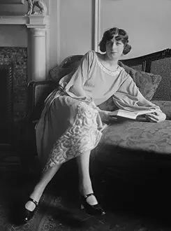 Comedienne Prints: Actress Fanny Brice, with open book, seated on sofa, c. 1920-25