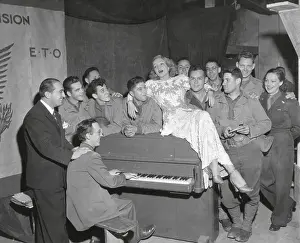 Movie Stars Prints: Actress Marlene Dietrich singing for a group of GI's in France
