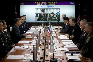 South Korea Prints: US Admiral Mike Mullen center right sits across the table from his South Korean counterpart center left to discuss