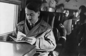 Passenger Prints: Adolf Hitler reading in airplane, ca. 1940. (BSLOC_2013_9_167)