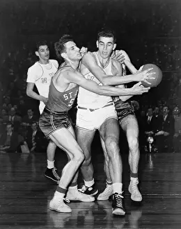 Guarding Prints: Adolph Dolph Schayes keeping the basketball away from Joe Ossola of St