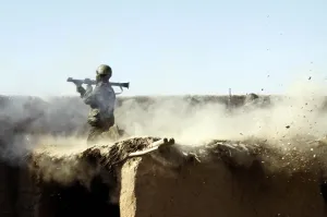 Deserts Prints: An Afghan National Army soldier fires a rocket-propelled grenade at Taliban insurgents from Marjeh Helmand province