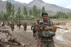 War On Terrorism Prints: Afghan soldiers patrol behind U