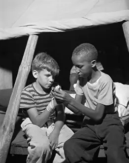 Helping Prints: African American camper helps a White bubby with his bandaged hand