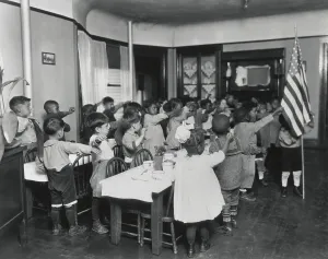 Patriotism Prints: African American children salute the flag in classroom