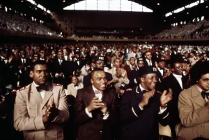 Black Power Prints: African American men applaud Black Muslim leader Elijah Muhammad during his Annual Savior's Day message in Chicago