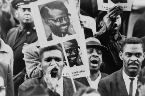 Executions Prints: African American men at a Black Muslim demonstration carrying placards with portrait of Patrice Lumumba