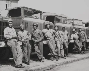 Trucks Prints: African American officers and mechanics standing in front of Army trucks