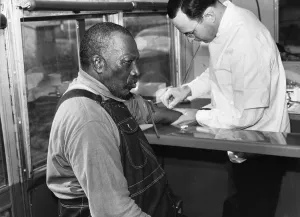 Arsenic Prints: African American patient receiving treatment for syphilis in public health service clinic-on-wheels
