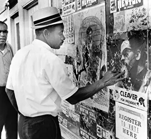 Black Panthers Prints: An African American pokes his finger into a bullet hole in the Oakland Black Panther's headquarters