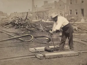 Protection Prints: An African American railroad construction worker straightens track for the Union during the Civil War