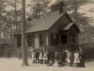 Aprons Prints: African American school children posed with their teacher outside a segregated one-room school