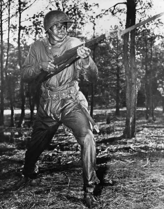 Charging Prints: African-American soldier charging with bayonet fixed during World War II combat training at the U
