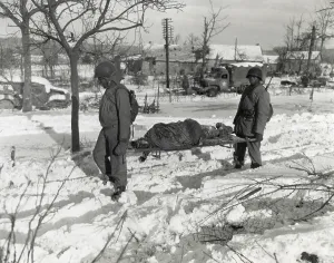 Non Combat Prints: Two African American soldiers carry the body of an soldier on a stretcher during World War 2