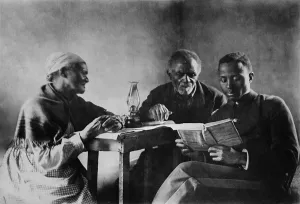 Parents Prints: African American son reading the Bible to his parents