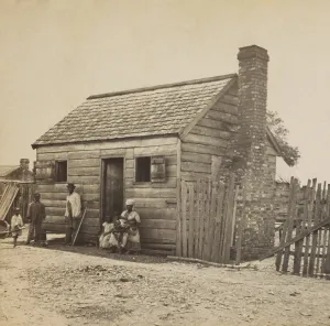 Liberation Prints: African American Uncle July and his family in front of their home on the Fripp plantation