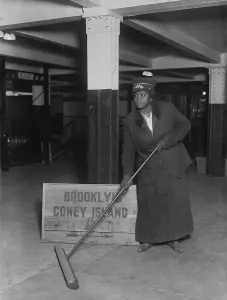 Brooklyn Prints: African American woman porter in the New York City Subway sweeping an underground station