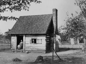 13th Amendment Prints: African American woman seated in log cabin doorway