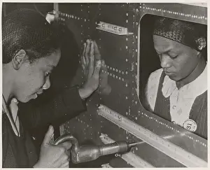 Laborer Prints: African American women riveters work on the center section of a bomber during World War 2
