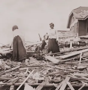 Texas Prints: Two African American women on rubble trying to find where their Galveston home stood