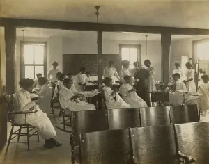 Teacher Prints: African-American women sewing by hand and with sewing machine in classroom, c. 1911-18